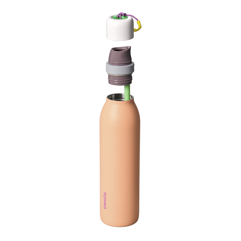 Owala FreeSip Twist 24oz in Peachy Keen, close-up of twist cap and carry string showing peach body, white twist cap with gray accent band, purple carry string, and yellow carry string grip